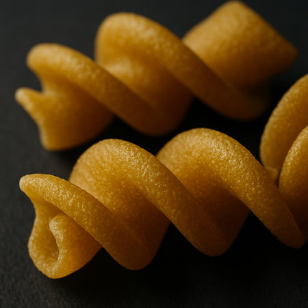 close up of uncooked italian fusilli pasta on black backgroundの素材
