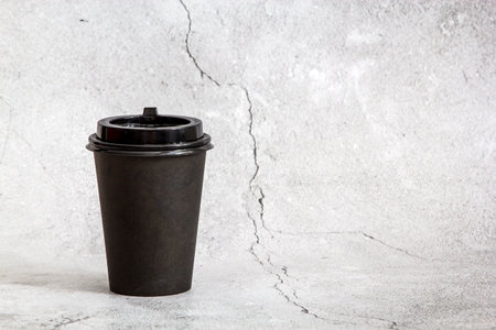 Disposable cup of coffee on a white background