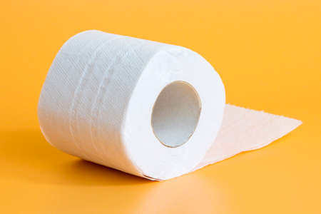Toilet paper roll on yellow backgroundの写真素材