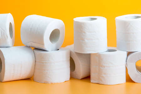 Toilet paper roll on yellow backgroundの写真素材