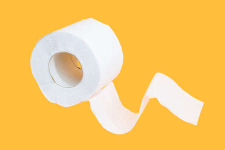 Toilet paper roll on yellow backgroundの写真素材