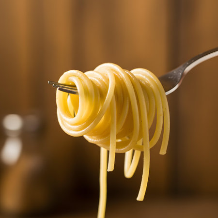 spaghetti on a fork on a wooden background. tinting. selective focusの素材