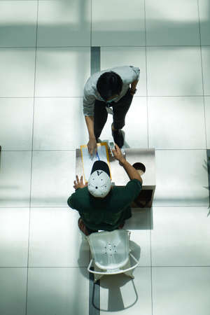 Kuala Lumpur, Malaysia- May 15 2020 : New normal, people are required to sanitize their hands before entering the business premises and keep social distancing to break the COVID-19 chain. Top angleのeditorial素材