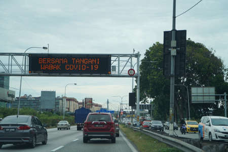 Kuala Lumpur, Malaysia - December 2019: View of the highway after the government announced to reduce the movement control order during COVID-19. Lots of cars on the street on a busy day.のeditorial素材