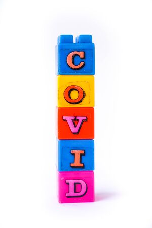 Covid words are arranged in a rustic colorful lego cube. Suitable for children. Isolated on white backgroundの写真素材