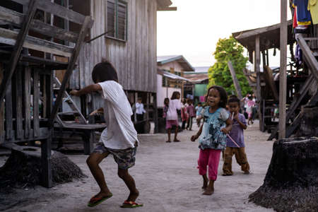 Mabul Island, Sabah, Malaysia - Aug 08, 2018: A happy face and enjoy of the Kids life on Mabul Island, they play with everything around themのeditorial素材