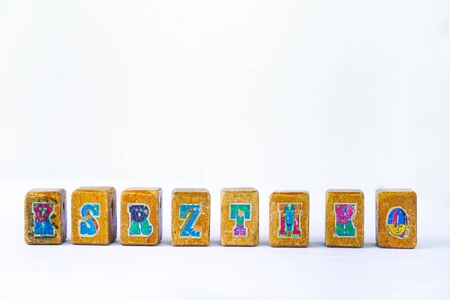 Cube wood with alphabet vintage kid toys isolated on white backgroundの写真素材