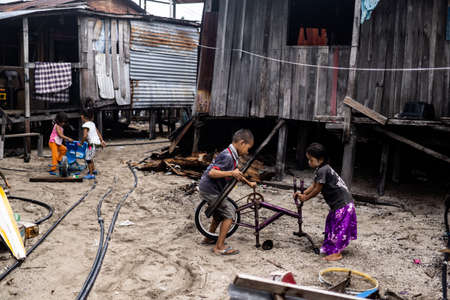 Mabul Island, Sabah, Malaysia - Aug 08, 2018: A happy face and enjoy of the Kids life at Mabul Island, they play with everything around themのeditorial素材