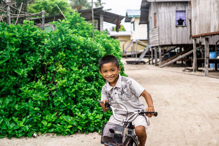 Mabul Island, Sabah, Malaysia - Aug 08, 2018: A happy face and enjoy of the Kids life at Mabul Island, they play with everything around themのeditorial素材