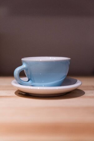 Blue small cup on the table. Image contains excessive noiseの写真素材