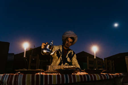 Morocco- September 28,2019 : Local people serve tea for tourist at Merzouga, Moroccoのeditorial素材