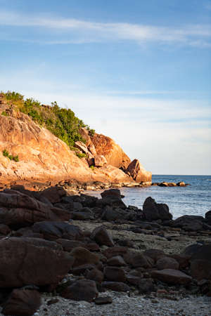 A tropical island with Cliffs and perfect bly sky at Long Beach Redang Islands, Malaysiaの写真素材