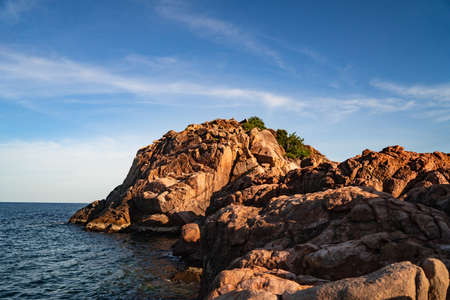 A tropical island with Cliffs and perfect bly sky at Long Beach Redang Islands, Malaysiaの写真素材