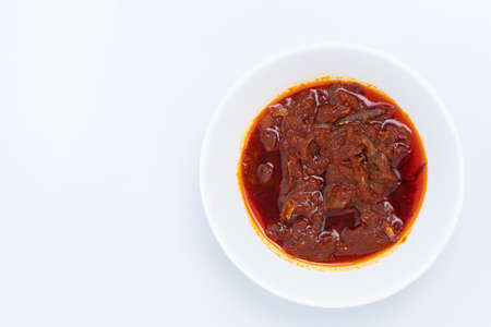 Top angle of "Sambal ikan bilis" suitable for nasi lemak or nasi impit Asian Inspirations, Stir-Fried Anchovies with hot chilies. A white background provides copy space to the left.の写真素材