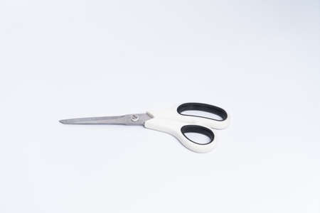 top view of a pair of white color plastic scissors isolated on white backgroundの写真素材