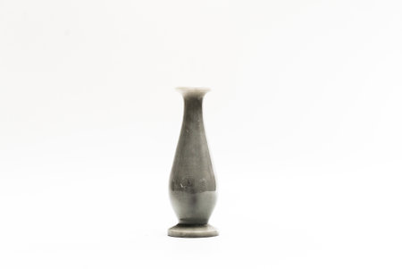 Dark grey ceramic curved vase for interior decoration. Studio shot and isolated on white backgroundの写真素材