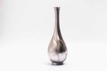 Isolated silver, reflective chrome, a tall vase for interior decoration. Studio shot and isolated on white backgroundの写真素材
