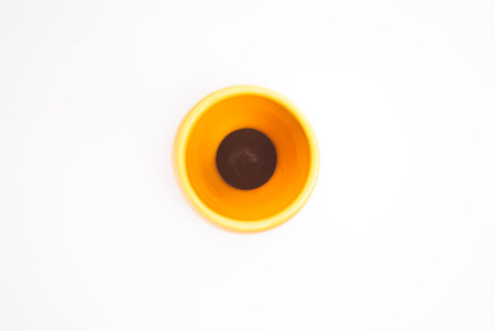 The top angle of the yellow curved vase for interior decoration. Studio shot and isolated on white backgroundの写真素材