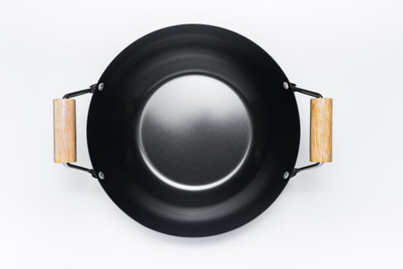 Top angle of the classic black pan with wooden handle. Isolated on white backgroundの写真素材