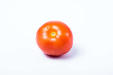Single delicious red tomato without stalk. Isolated on white backgroundの写真素材