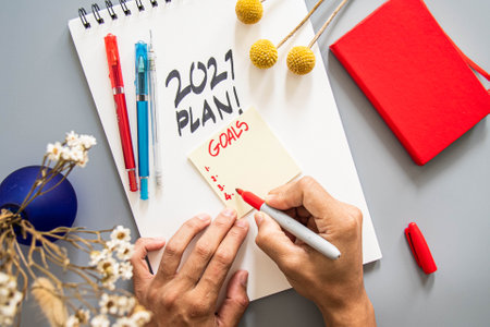 2021 plan notepad list concept, handwriting notepad. Inscription "2021 Plan" in white paper and "focus !, target !, money!" in notepad, close up, top view, concept of planning, goal setting.の写真素材