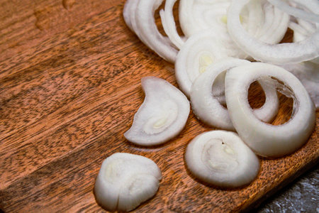 slice onion on wooden cutting boardの写真素材
