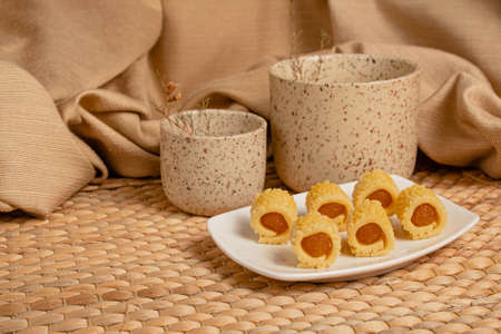 Delicious homemade pineapple roll tart for eid fitr on a with plate. Copy spaceの写真素材