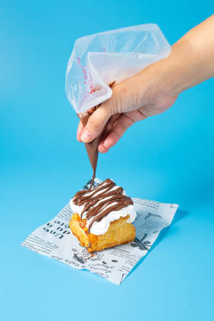 puff pastry pie with fresh fruits. Hand holding slice of strawberryの写真素材