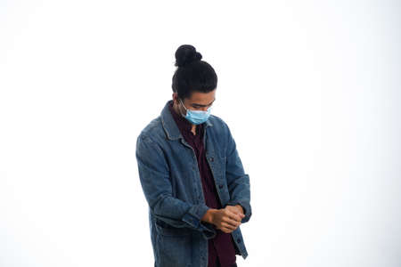 health, pandemic and safety concept - asian young man wearing face protective medical mask for protection from virus disease over white backgroundの写真素材