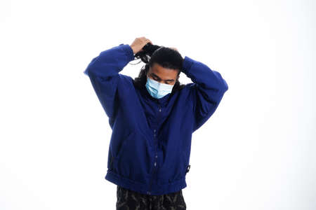 health, pandemic and safety concept - asian young man wearing face protective medical mask for protection from virus disease over white backgroundの写真素材