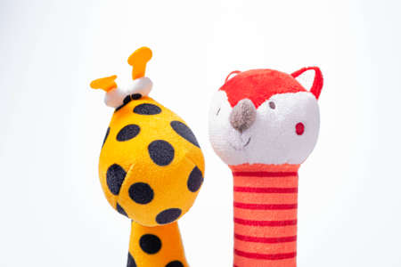 Little yellow giraffe and red fox soft toys isolated on white background. copy spaceの写真素材