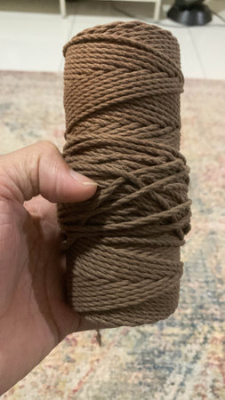 Holding the brown Macrame Single Strand Cotton Cordの写真素材