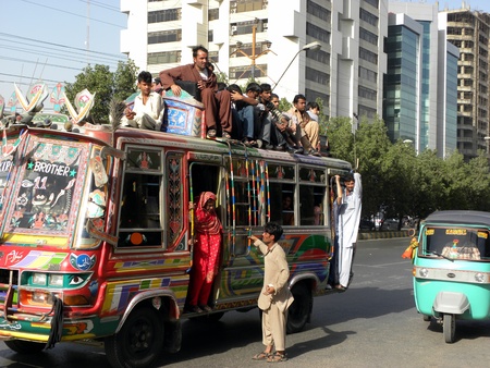 LOCAL_PUBLIC_SITTING ON THE BUS_ROOF_DUE TO_UN SPACE_IN BUS_TODAY ON THURSDAY_15/3/2012_ KARACHI/PAKISTAN                             のeditorial素材