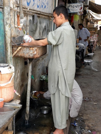 PAKISTAN/KARACHI_LOCAL BOY IN CHILD LABOUR DOING DISHWASHING TEA CUPS TODAY ON  TUESDAY 1 MAY 2012 I KARACHI                              のeditorial素材