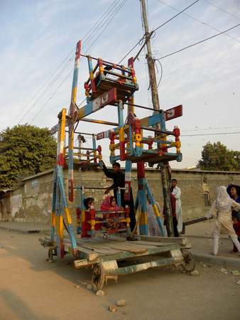 KARACHI PAKISTAN_KIDS ENJOYING THEIR FOVOURITE RIDE NEAR THEIR HOME IN STREET HERE ON MONDAY 25...