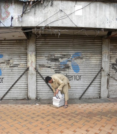 KARACHI PAKISTAN_ FRIDAY ,4 APRIAL 2014 Newspaper distributors sorting news papers at newspaper distribution point  Newspaper distributors sorting news papers at newspaper distribution point, A newspaper is a scheduled publication containing news of curreのeditorial素材