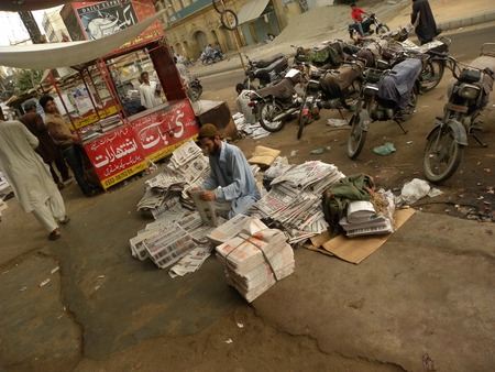 KARACHI PAKISTAN_ FRIDAY ,4 APRIAL 2014 Newspaper distributors sorting news papers at newspaper distribution point  Newspaper distributors sorting news papers at newspaper distribution point, A newspaper is a scheduled publication containing news of curreのeditorial素材