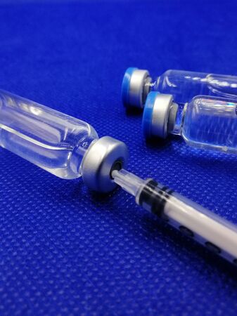Vaccination concept. Syringe with needle and bottles of liquid.の写真素材