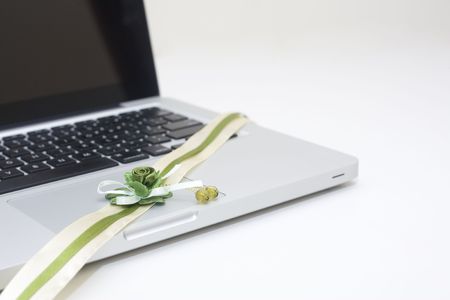 Green ribbon flower on the note bookの写真素材