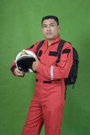 Portrait of man firefighter isolated on greenの写真素材
