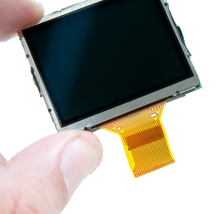 Holding the LCD screen of digital camera isolated on white