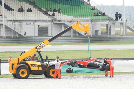 SEPANG, MALAYSIA - APRIL 8: The crane lift up crashes F1 car of Jerome d'Ambrosio of Marussia Virgin...