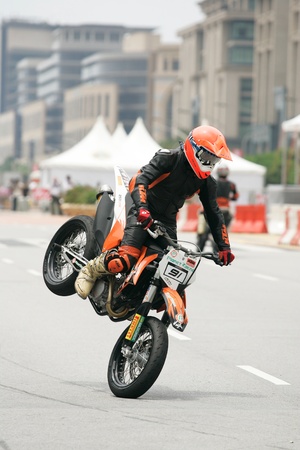 PUTRAJAYA, MALAYSIA - APRIL 2: Unidentified rider of supermotard in action during F1 street demonstration on April 2, 2011 in Putrajaya, Malaysia. The event is a promotion for F1 Malaysia Grand Prix 2011.のeditorial素材