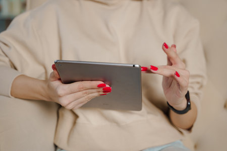Close up of young women using digital tablet in the office. Woman working on a tablet .の写真素材