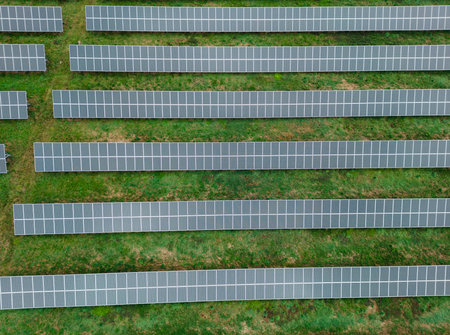 A breathtaking aerial shot of solar panels dotting the landscape as far as the eye can see. The image is a testament to the power of innovation and human ingenuity in creating a cleaner, brighter future.の写真素材