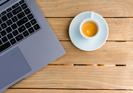 Top view comfortable workplace with laptop computer, coffee cup and notebook.の写真素材
