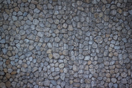 The  stone walls, modern look of the structure of rocks of different sizes.