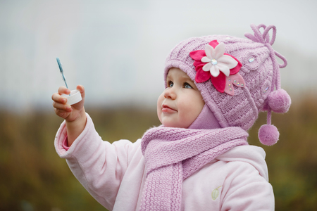 A littlegirl  blows bubbles in autumn dayの写真素材