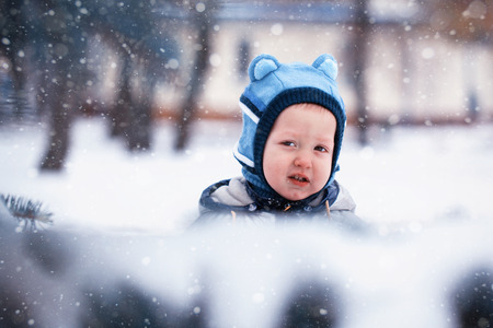 closeup portrait Little winter baby, snowingの写真素材