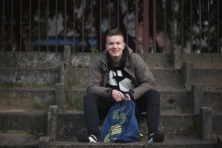 portrait of a young handsome man with  in nature backpack